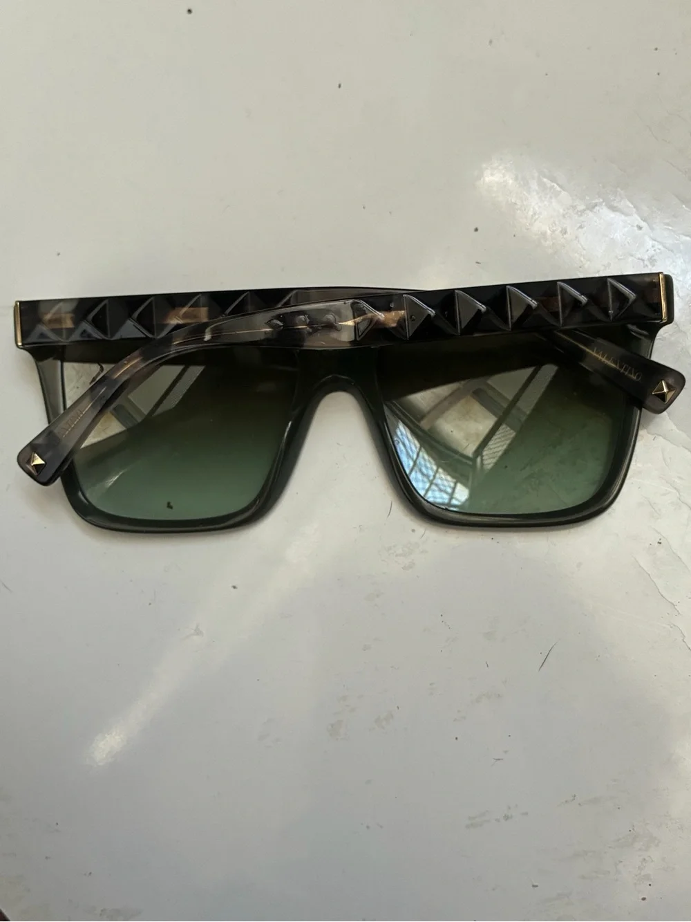 Valentino tortioshell sunglasses w a green lense and signature rockstuds on arms